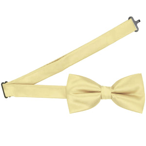Pre-tied light yellow bow tie with the band collar open