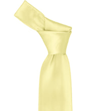 Load image into Gallery viewer, Close-up of a solid light yellow necktie knot, highlighting the soft tone and subtle ribbed texture of the fabric.