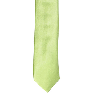 The front of a lime green skinny tie, laid flat