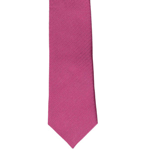 The front of a magenta pink slim tie with a herringbone tone on tone pattern, laid out flat
