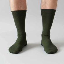 Load image into Gallery viewer, Olive green socks worn by a person on a light gray background