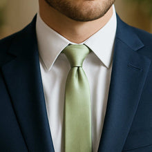 Load image into Gallery viewer, Groomsman wearing sage green slim tie with navy blue suit for wedding