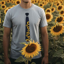 Load image into Gallery viewer, Man wearing a sunflower necktie t-shirt in a sunflower field