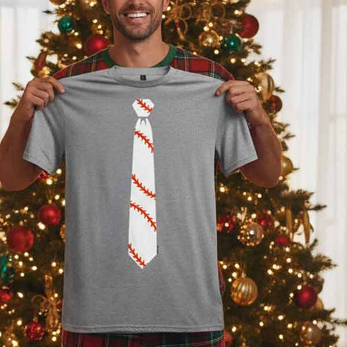 Man holding up a necktie t-shirt on Christmas morning