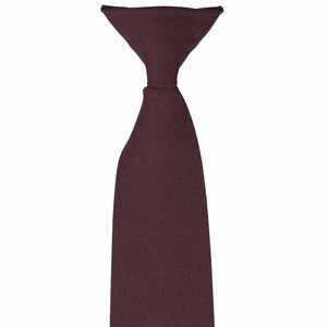 The front knot on a maroon matte-finish clip-on uniform tie