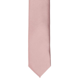 The front of a mauve skinny solid tie, laid flat