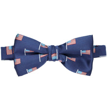 Load image into Gallery viewer, A dark blue bow tie with an all-over American flag pattern laid flat