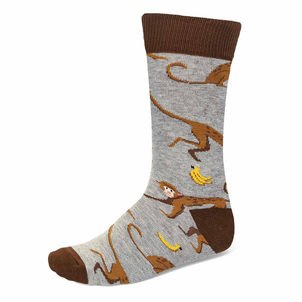 A brown and gray men's sock with monkeys and bananas all over