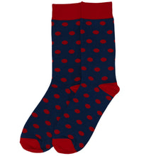 Load image into Gallery viewer, A pair of navy blue crew socks with a red polka dot pattern, featuring solid red cuffs, heels, and toes, displayed against a plain white background.