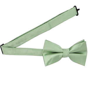 A mint green pre-tied bow tie with the band collar open