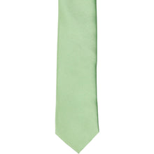 Load image into Gallery viewer, The front of a mint green skinny solid tie, laid flat