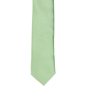 The front of a mint green skinny solid tie, laid flat