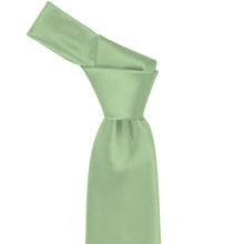 Load image into Gallery viewer, Close-up of a solid mint green necktie knot, highlighting the fresh green tone and subtle ribbed texture of the fabric.