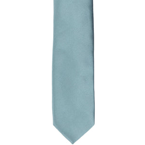 The front of a mystic blue skinny tie, laid flat