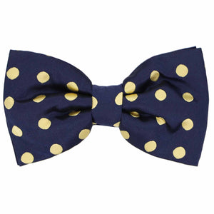 A navy blue bow tie with pale gold polka dots