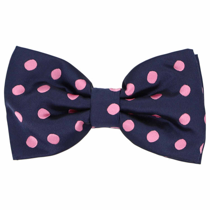 This men's navy blue pre-tied bow tie features fun pink polka dots