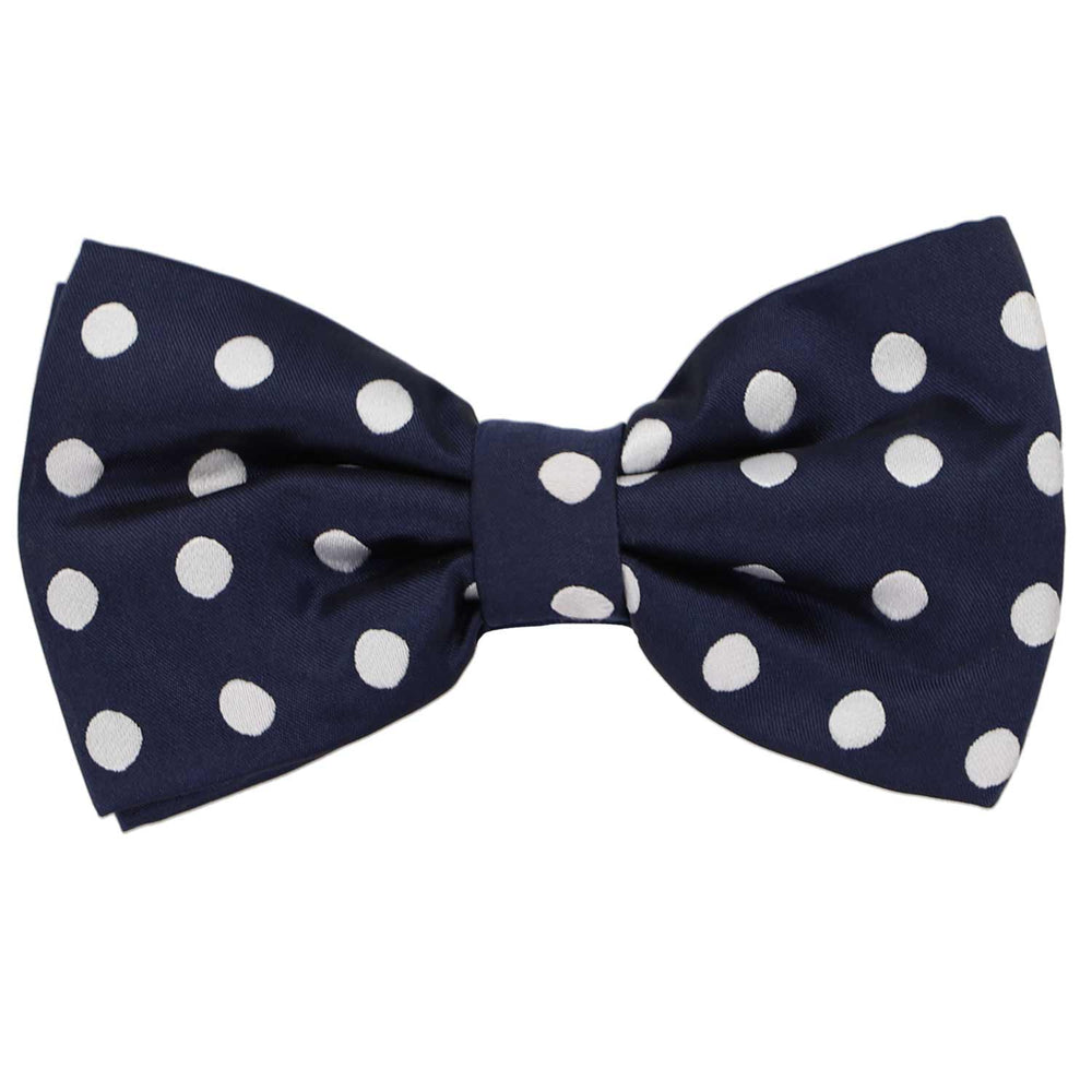 This navy blue pre-tied bow tie features a white polka dot pattern