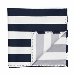 A navy blue and white striped pocket square with the corner flipped up to show back side
