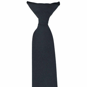 The top of a knot on navy blue clip-on uniform tie