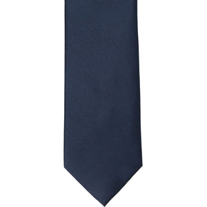 The front of a navy blue silk tie, laid out flat