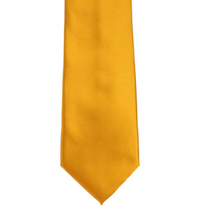 The front of a solid nugget gold color necktie, laid flat