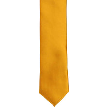 Load image into Gallery viewer, The front of a nugget gold solid skinny tie, laid out flat