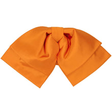 Load image into Gallery viewer, The bow on a bright orange floppy bow tie, set against a white background