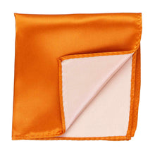 Load image into Gallery viewer, An orange pocket square with the corner flipped up to show the inside