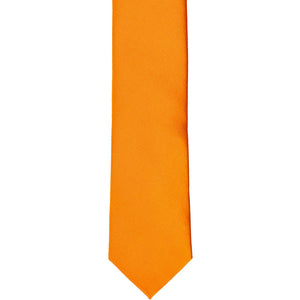 The front of an orange skinny tie, laid flat