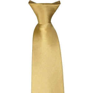 The front of a knot on a pale gold clip-on tie