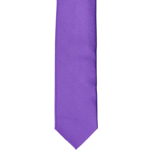 The front of a pansy purple skinny tie, laid flat