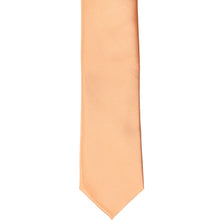 Load image into Gallery viewer, The front of a peach skinny tie, laid flat