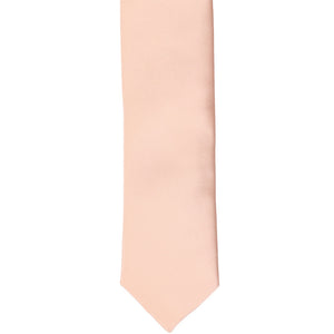 The front of a petal pink skinny tie, laid flat