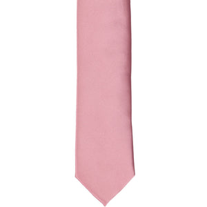 The front of a pink champagne skinny tie, laid flat