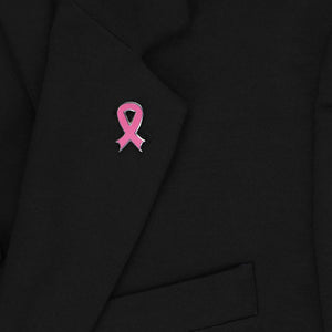 A pink ribbon lapel pin on a black jacket