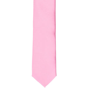 The front of a pink skinny tie, laid flat