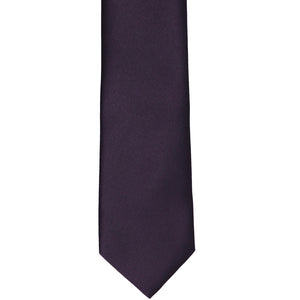 The front of a plum slim tie, laid out flat