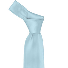 Load image into Gallery viewer, Close-up of a solid powder blue necktie knot, highlighting the soft blue tone and subtle ribbed texture of the fabric.