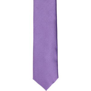 The front of a purple solid skinny tie, laid out flat