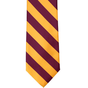 Front view of a raspberry and golden yellow striped tie, laid out flat