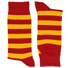 Load image into Gallery viewer, A pair of red and golden yellow striped knit socks shown flat against a white background, with one sock standing upright and the other laid on its side to show the heel and toe.