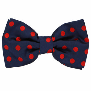 This navy blue bow tie features red polka dots