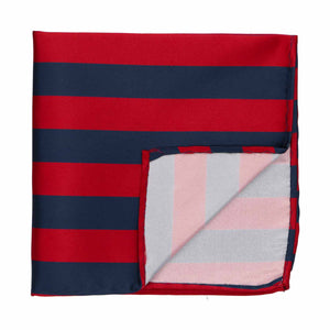 A red and navy blue striped pocket square with the corner flipped up to show the backside
