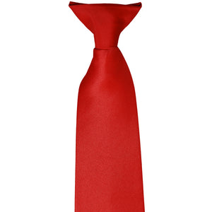 The pre-tied knot on a red clip-on tie