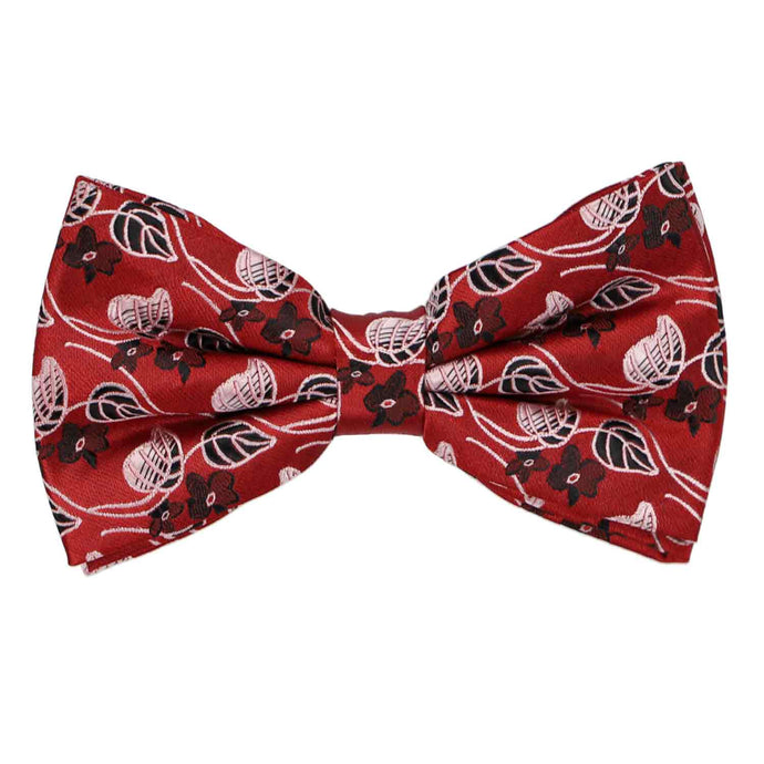 Vibrant red pre-tied bow tie featuring a unique floral and leaf pattern