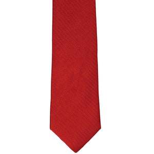 The front of a red herringbone slim tie, laid out flat