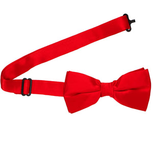 A pre-tied red silk bow tie with its band collar open
