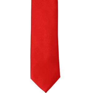 The front of a red slim tie, laid out flat