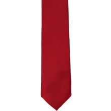 Load image into Gallery viewer, The front of a red skinny silk tie in a solid color, laid out flat