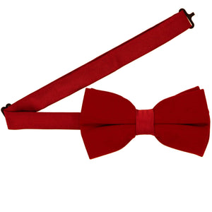 A red velvet pre-tied bow tie with an adjustable band collar spread out